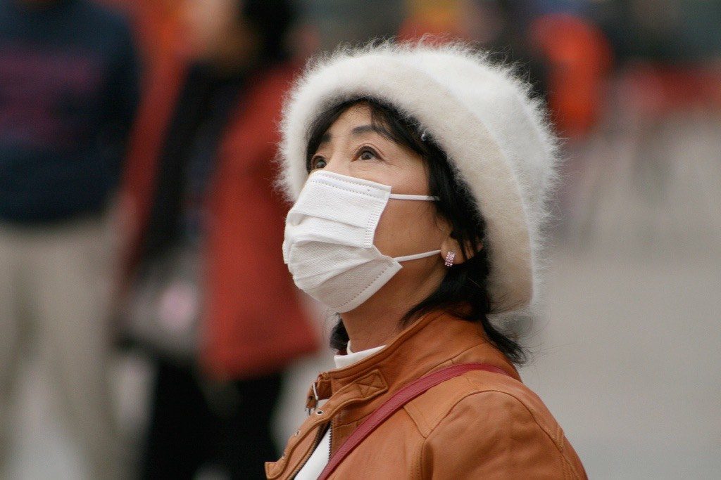 Chinese Woman Wearing Face Mask to Prevent from Breathing Contaminated Air