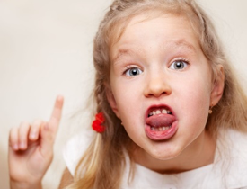 Young child holding up one finger and rolling their tongue