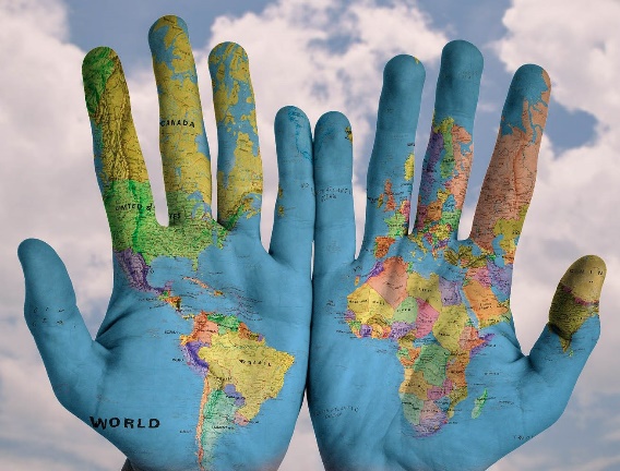 Persons hands covered with a world map