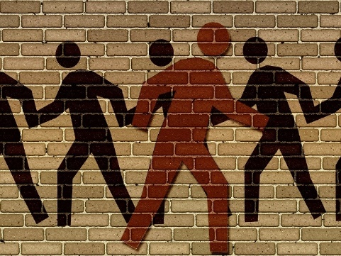 Illustration of silhouettes painted on a brick wall