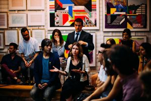 A group of people are meeting and discussing in a room.