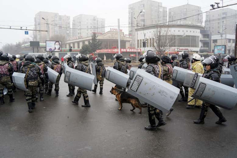 A line of riot police gather to block demonstrators during a protest in Kazakhstan's capital.