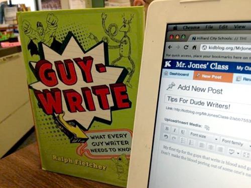 Book "Guy-Write" sitting next to laptop with blog post on screen
