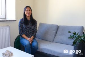 Mrs. My Hanh Nguyen, sitting on a couch and smiling