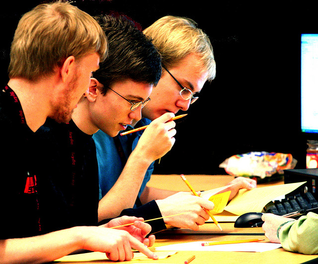 Four male students working on homework together