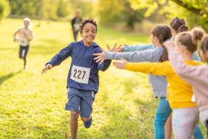 A happy child running a race.