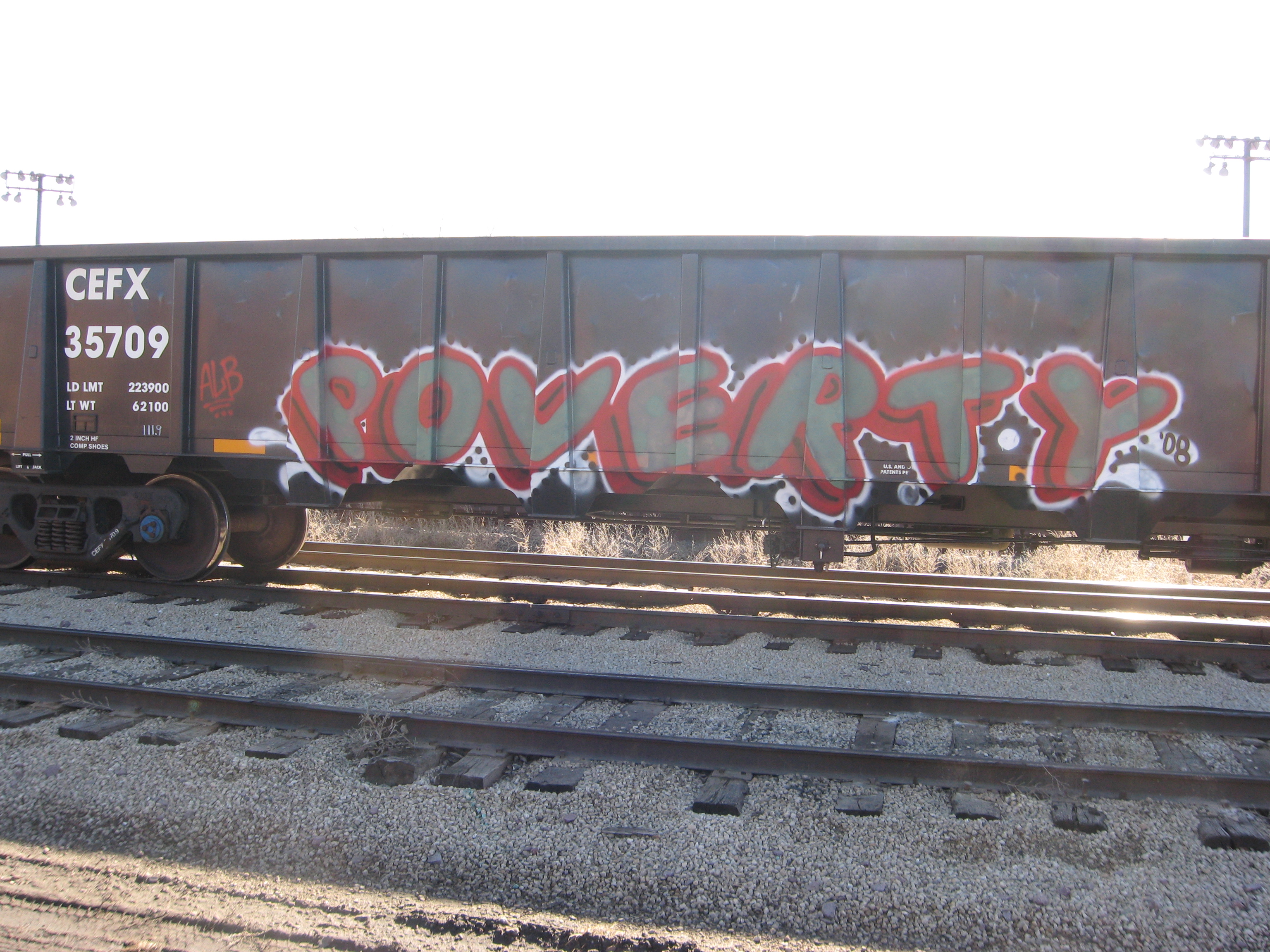 train car with graffiti spraypainted with the word poverty