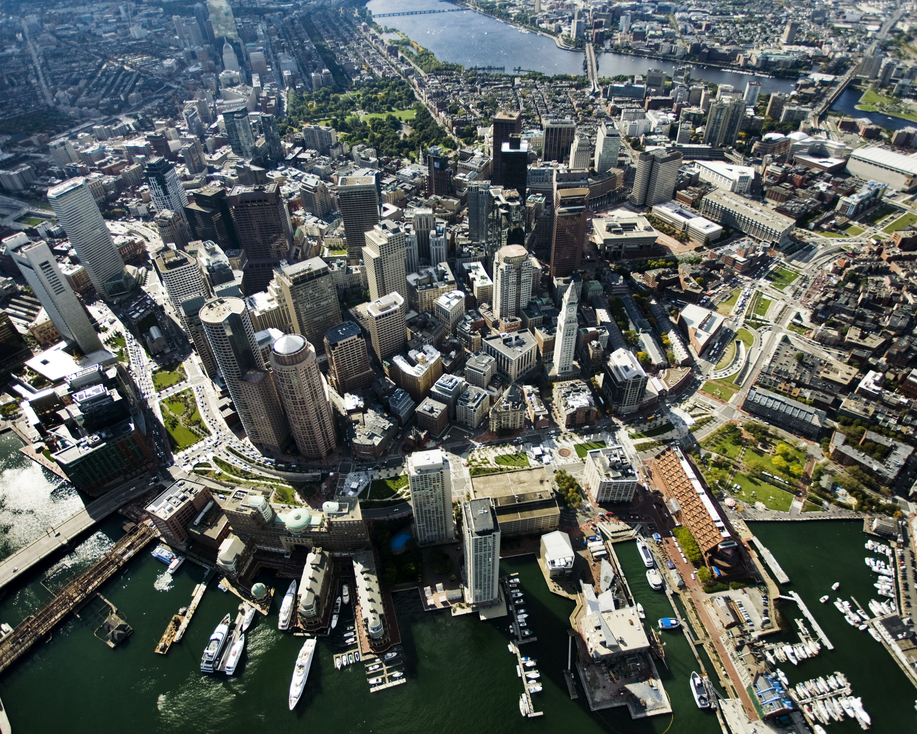 aerial view of a city with a path of open, green space running through it