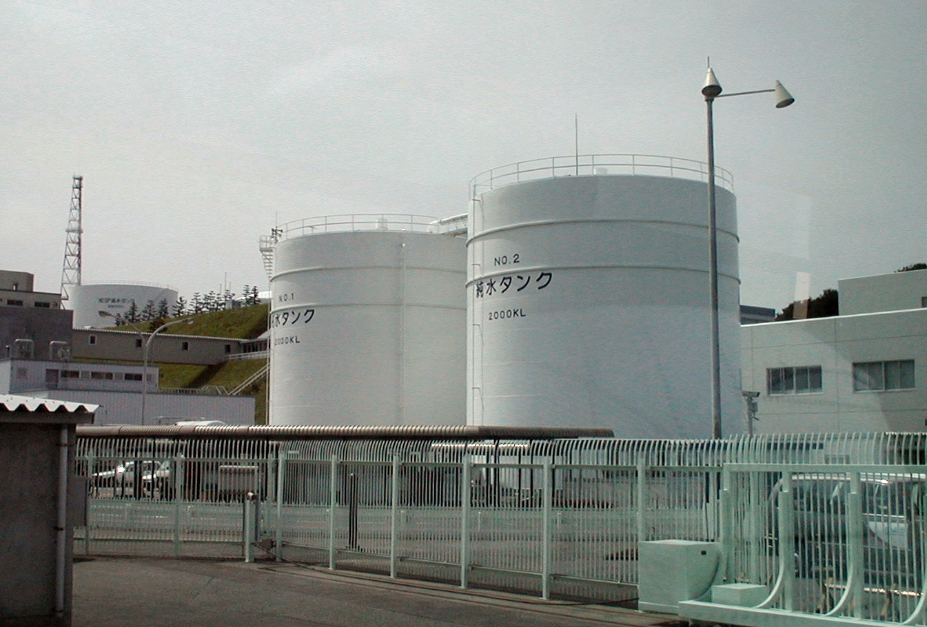 two reactors at the Fukushima Nuclear Power behind a metal fence